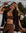 Woman in brown bralette outfit with sunglasses against a snowy mountain background